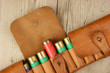 Old hunting cartridges and bandoleer on a wooden table