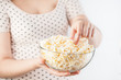 Girl on black dots t-shirt holding popcorn bowl