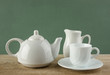 white ceramic coffee set on old wooden table over green backgrou