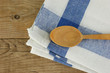 wooden kitchenware  and dishcloth on old wooden table
