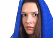 Muslim girl wearing a blue rug with a fear in her eyes