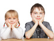 Sister and brother sitting at desk