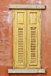 Brown wooden window on brick wall