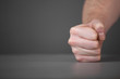Male fist on the table.