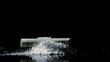 Rolled up dollar note falling on pile of white drug close up