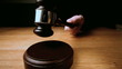 Judge hammering gavel onto sounding block