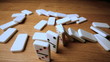 The domino effect on wooden table high angle shot