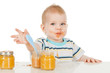 Photo: Boy eats with a spoon puree, isolated on white Boy eats with a spoon puree, isolated on white