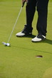 Man playing golf, Golfer Sinking an Early Morning Putt