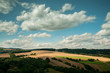 Sunny fields with a cloudy sky.