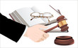 wooden gavel in hand and law books isolated on white