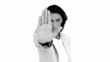 Businesswoman telling you to halt in black and white