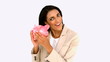Video: Businesswoman shaking piggy bank Businesswoman shaking piggy bank