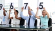 Business people holding grades