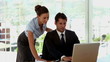 Businesswoman helping a colleague