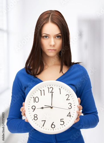 Photo: woman holding big clock woman holding big clock