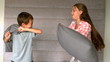 Siblings having a pillow fight
