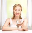 Foto: young smiling woman with glass of water young smiling woman with glass of water