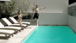 Brother and sister diving into the swimming pool