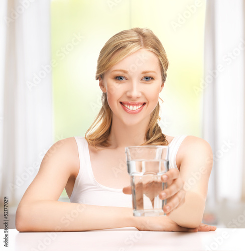 Photo: young smiling woman with glass of water young smiling woman with glass of water