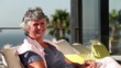 Vidéo : Mature woman smiling at camera on balcony Mature woman smiling at camera on balcony