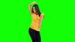 Woman dancing with arms raised on green screen