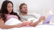 Couple reading books in bed