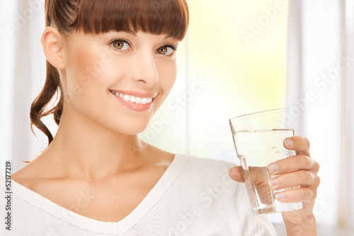 Photo: young smiling woman with glass of water young smiling woman with glass of water