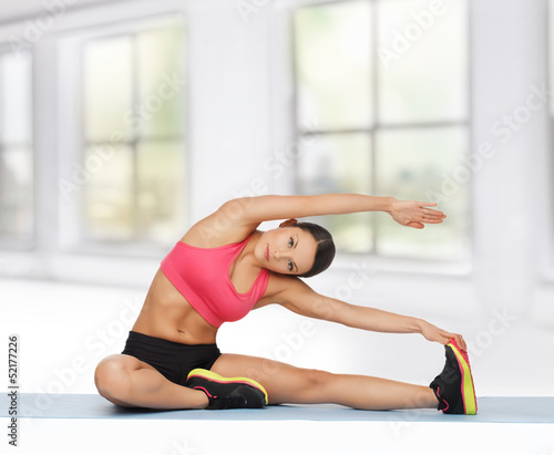 Photo: sporty woman doing exercise on the floor sporty woman doing exercise on the floor