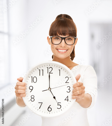 Photo: businesswoman with wall clock businesswoman with wall clock