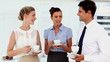 Laughing business people having a conversation at break time