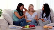 Pretty friends chatting together on the couch