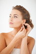 woman wearing shiny diamond earrings