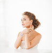 woman with pearl earrings and bracelet