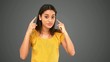 Woman pointing to her temples on grey background