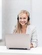 friendly female helpline operator with laptop