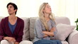 Couple arguing on the couch at home and getting angry