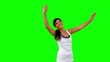 Woman in sportswear stretching her arms on green screen