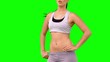 Athletic woman tossing hair on green screen