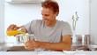 Man pouring orange juice in his glass in slow motion