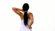 Fit woman stretching her neck and back on white background