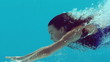 Woman swimming underwater in slow motion