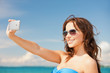 woman in bikini with phone