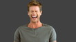 Man laughing on grey screen