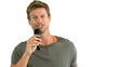 Man with microphone singing on white background