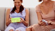 Woman opening a present at her baby shower