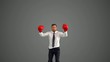 Businessman in boxing gloves leaping and punching his fists