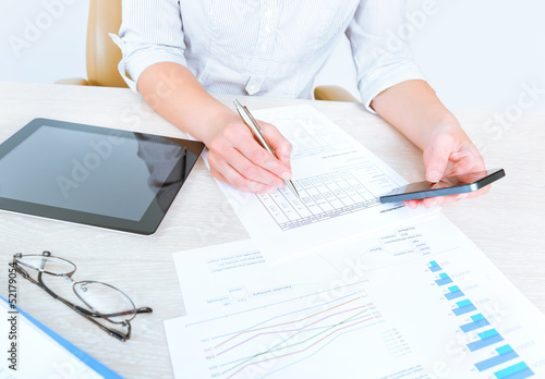 Photo: Business person analyzing statistics Business person analyzing statistics