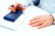 Photo: Closeup of a businessman calculating Closeup of a businessman calculating
