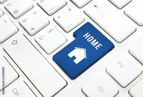Illustration: Home or real estate concept, blue house key on a keyboard Home or real estate concept, blue house key on a keyboard
